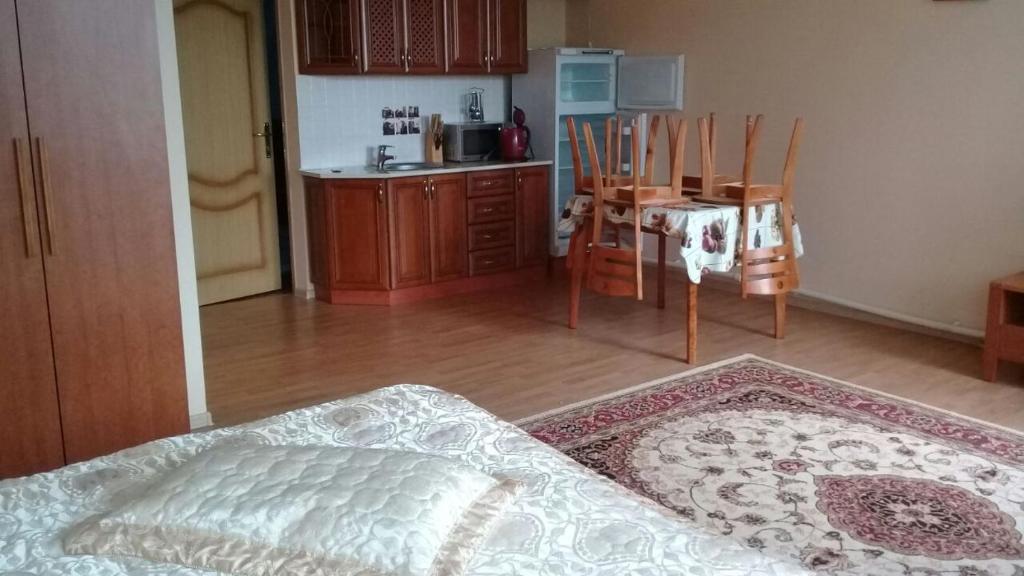 a kitchen with a bed and a table and chairs at Зона Отдыха Тихий Залив in Topar