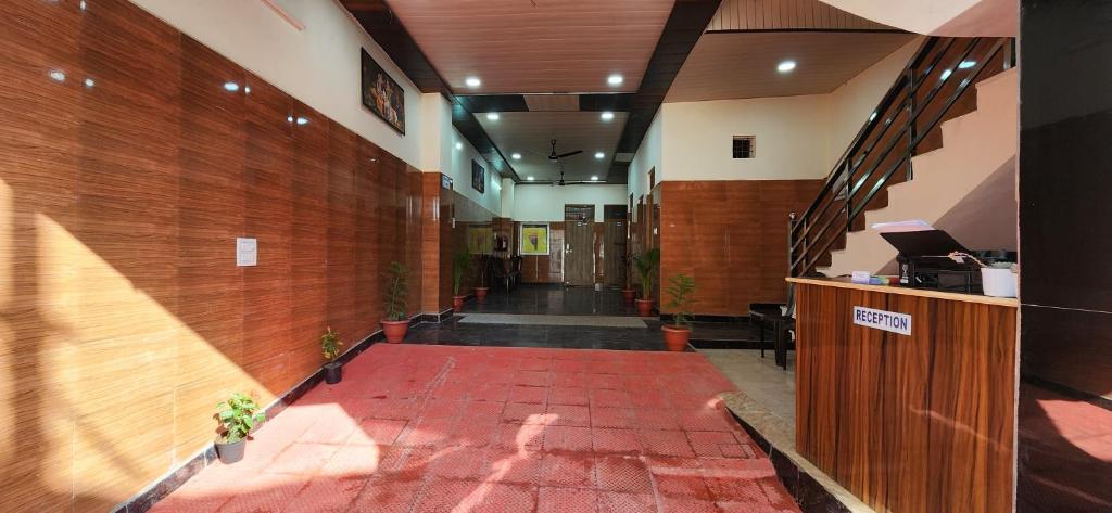 a hallway with a red carpet in a building at Shree Radha Rani Dham, Near Iskcon and Prem Mandir in Vrindāvan
