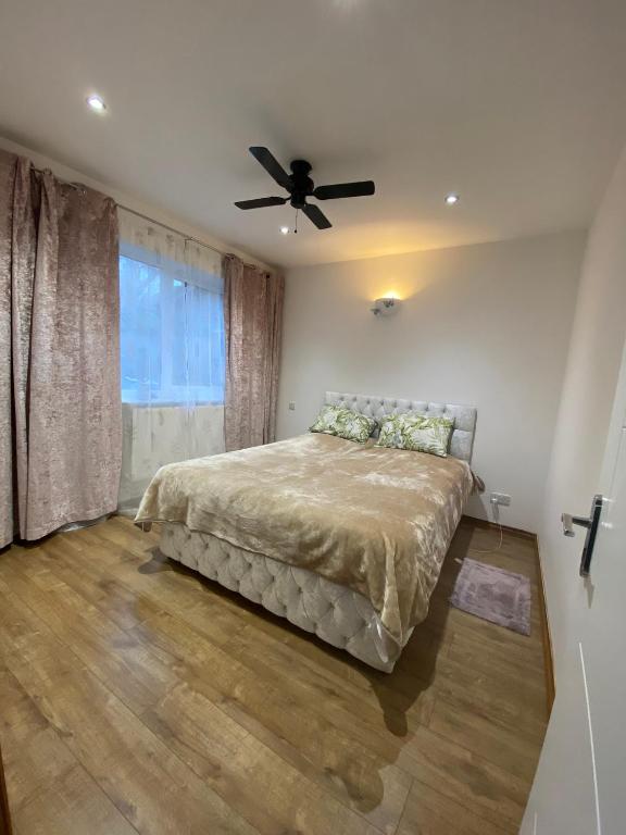 a bedroom with a bed and a ceiling fan at Double room in St. Albans