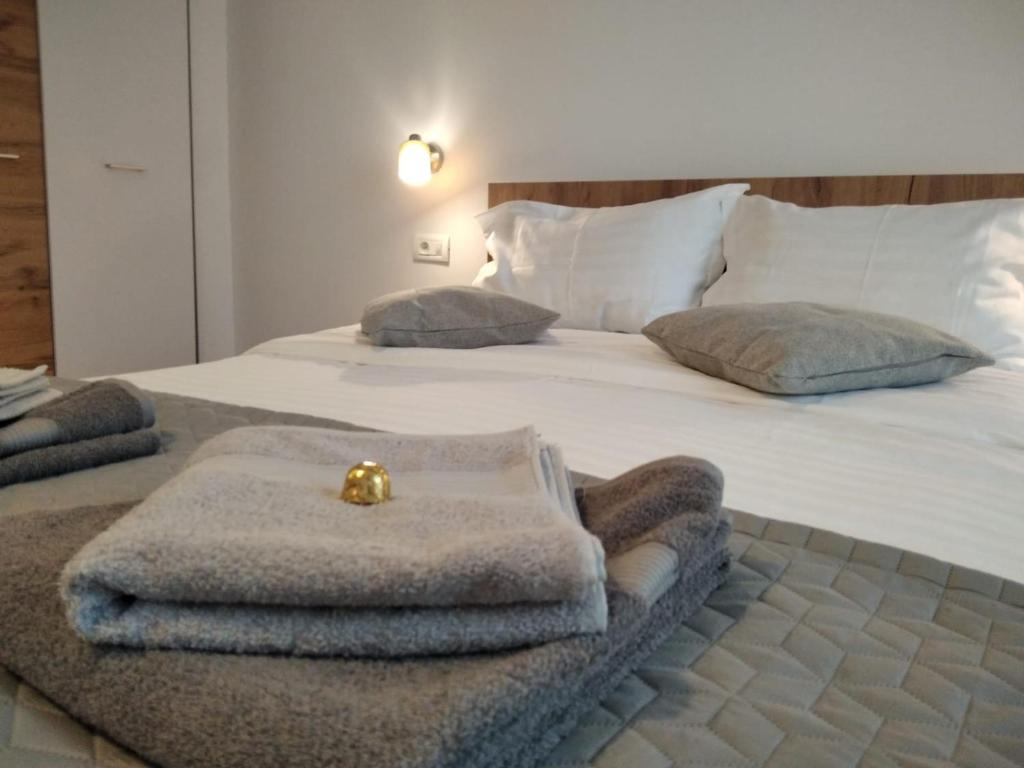 a bedroom with a bed with towels on it at FRIENDS House - Central Station - Self Check-in in Braşov