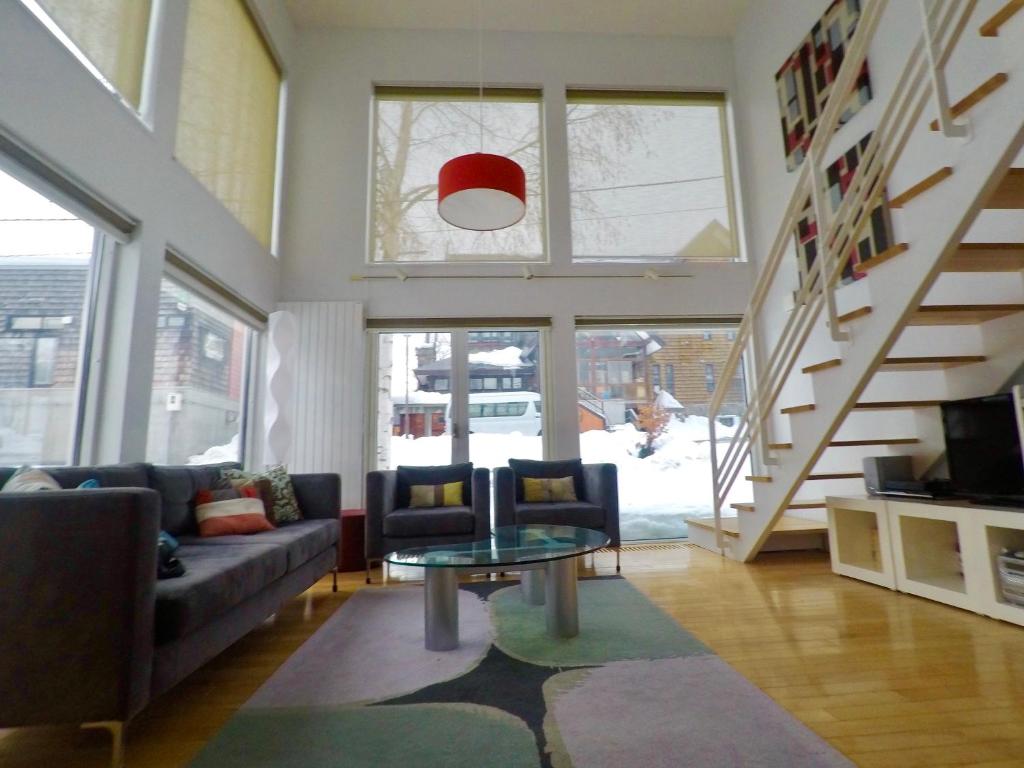 a living room with a couch and a table at Hirafu House 7 in Ōmagari