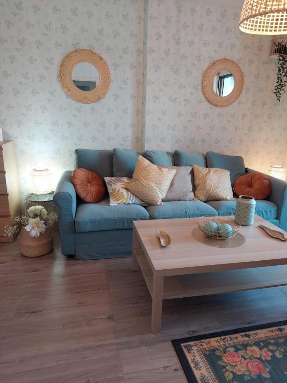 a living room with a blue couch and a coffee table at Chic Home Tropical beach Motril with garage in Motril
