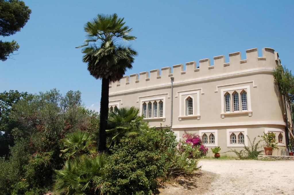 un palmier devant un bâtiment dans l'établissement Château du Fenouillet - Logement Porquerolles 72M2, à Hyères