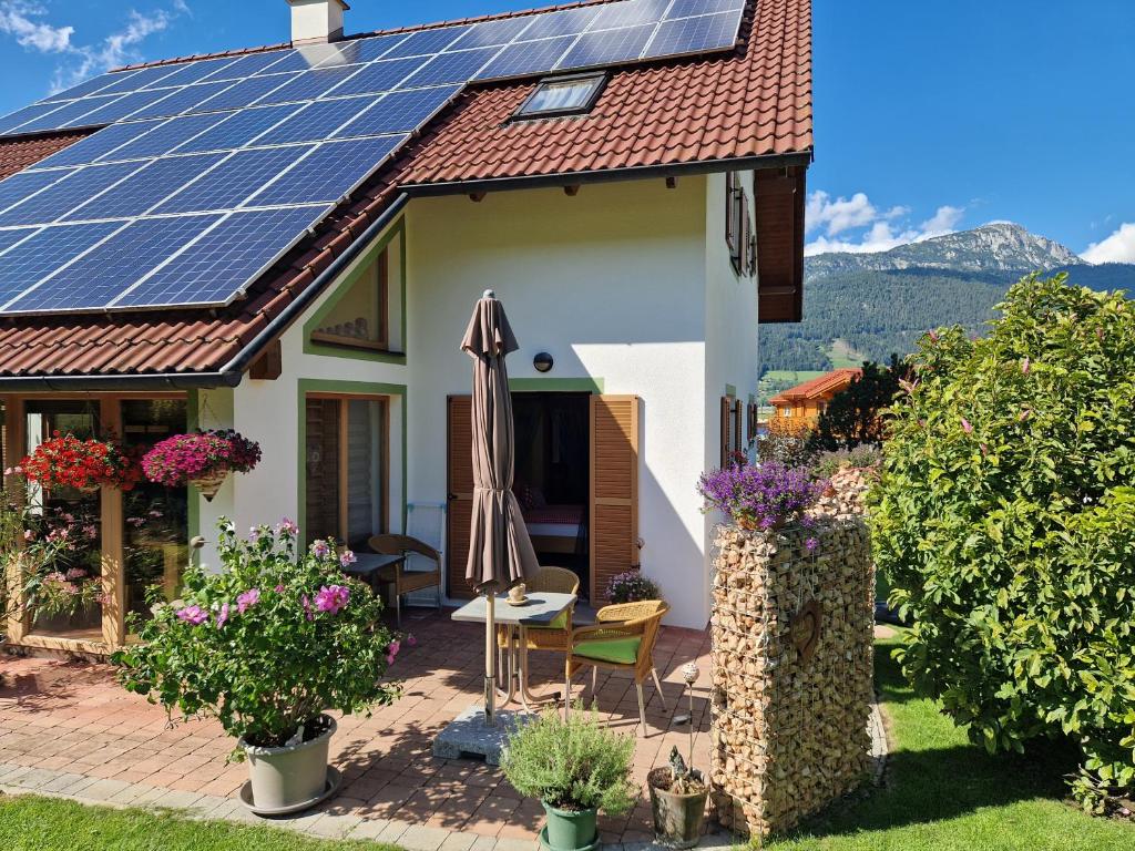 a house with solar panels on the roof at Appartement BERGTRÄUME in Haus im Ennstal