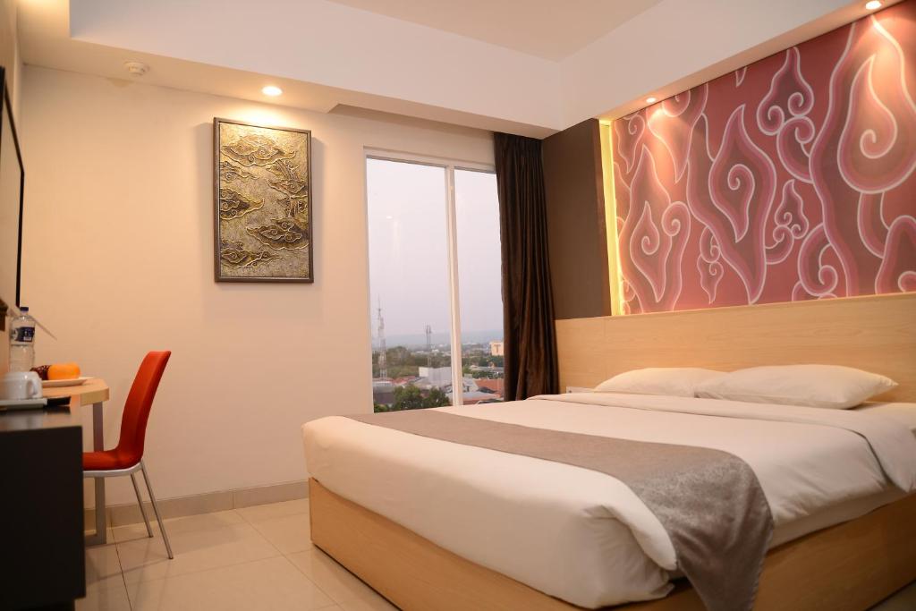 Postel nebo postele na pokoji v ubytování Metland Hotel Cirebon