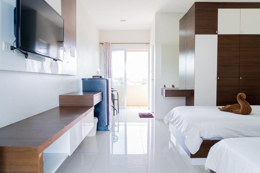 Postel nebo postele na pokoji v ubytování The Infinity Suite Chiangrai