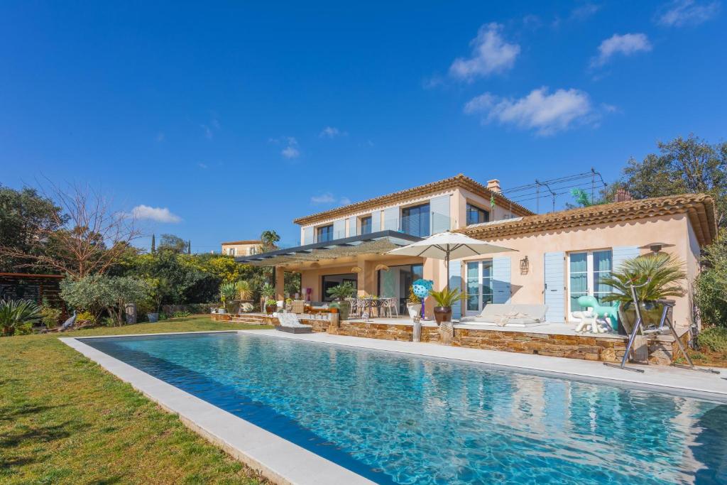 a house with a swimming pool in front of a house at villa 250 m² Vue mer Luxe parking in Grimaud