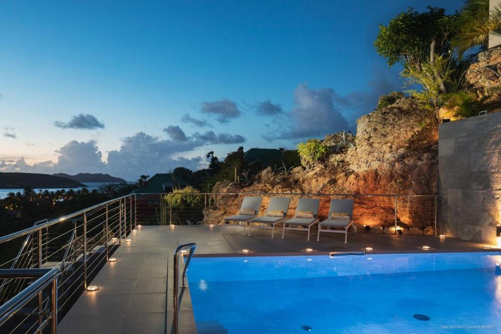 a villa with a swimming pool at night at Luxury Vacation Villa 15 in Saint Barthelemy