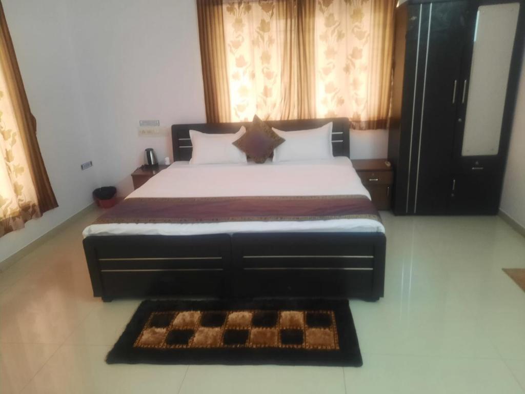 a bedroom with a large bed with a large window at CORPORATE STAY SOLUATION GANDHINAGAR 109/2 in Ahmedabad