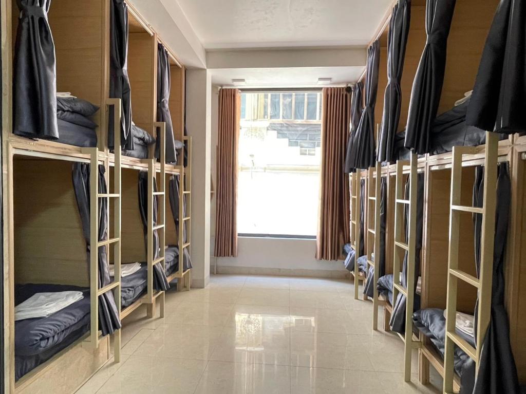 a room with multiple bunk beds with a window at Nhật's Sapa Central Hostel in Sa Pa