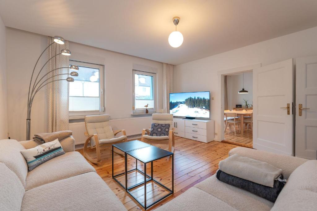 a living room with a couch and a tv at Ferienhaus Maria 6 Schlafzimmer & Sauna in Ostseebad Koserow