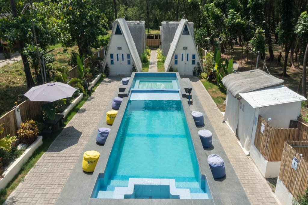 an overhead view of a swimming pool with two buildings at Costas De Liwa Bar & Beach Resort in Zambales