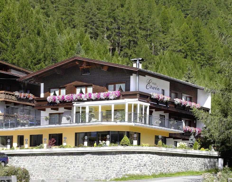 a large building with flowers on the balconies of it at Haus Erwin Appartement in Sölden