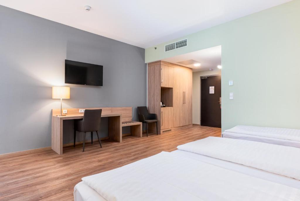A bed or beds in a room at Akeah Verdi Budapest