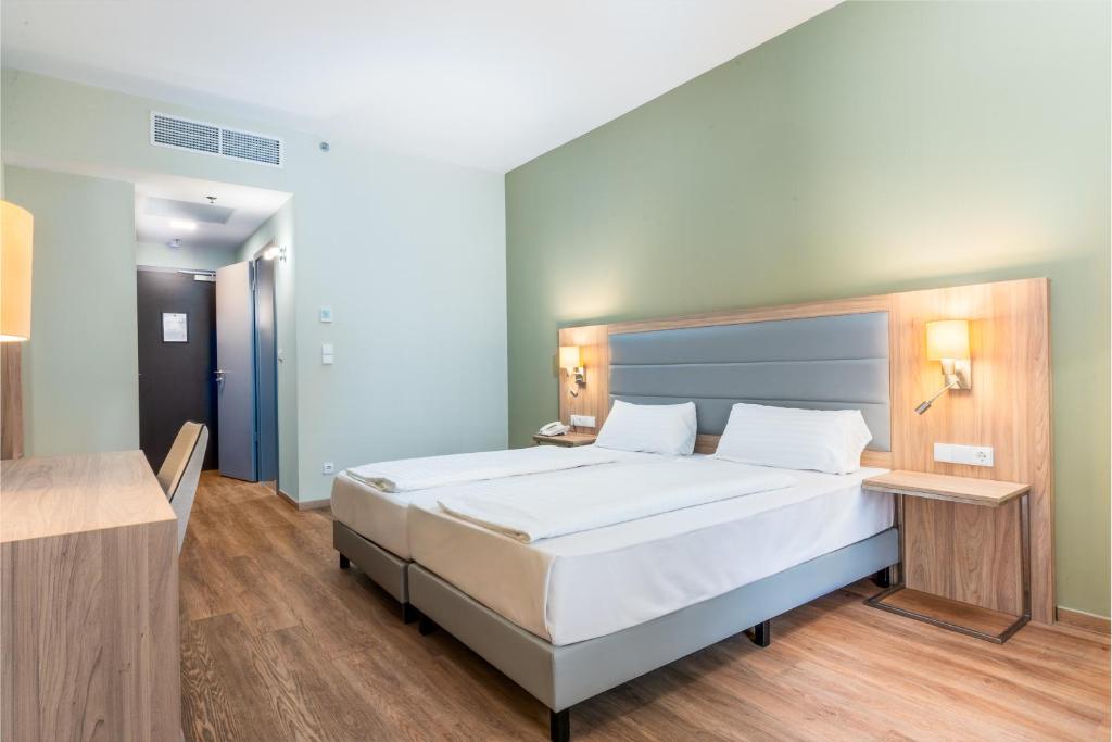 A bed or beds in a room at Akeah Verdi Budapest