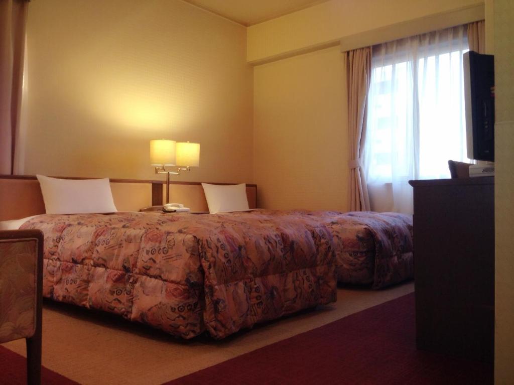 Postel nebo postele na pokoji v ubytování Apoa Hotel