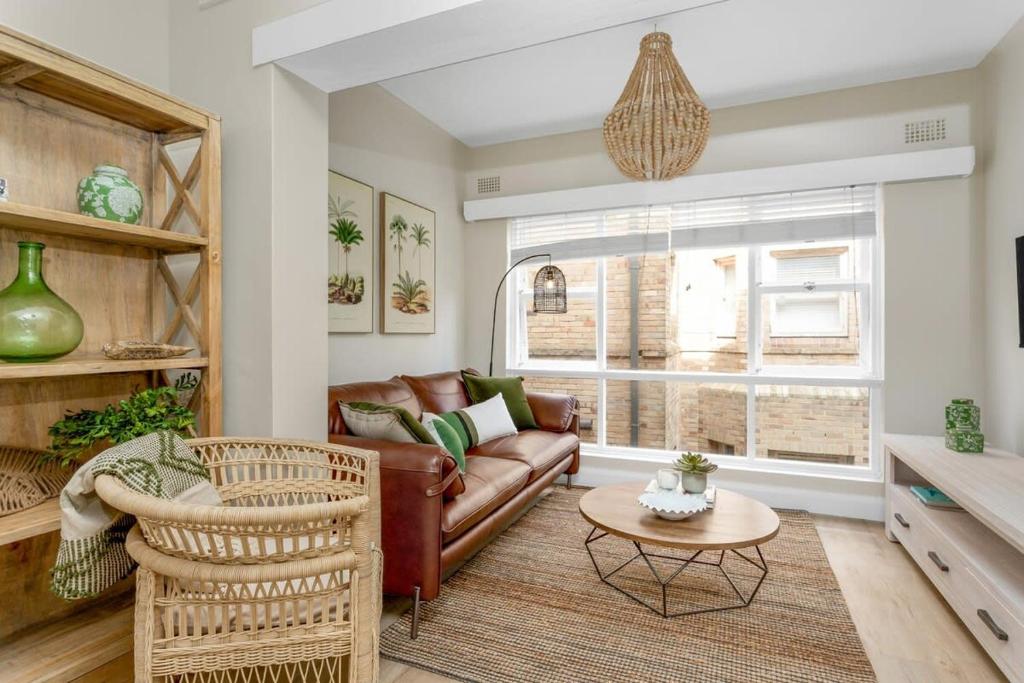 a living room with a couch and a table at Spacious 2-Bed Apartment in the heart of Manly in Sydney