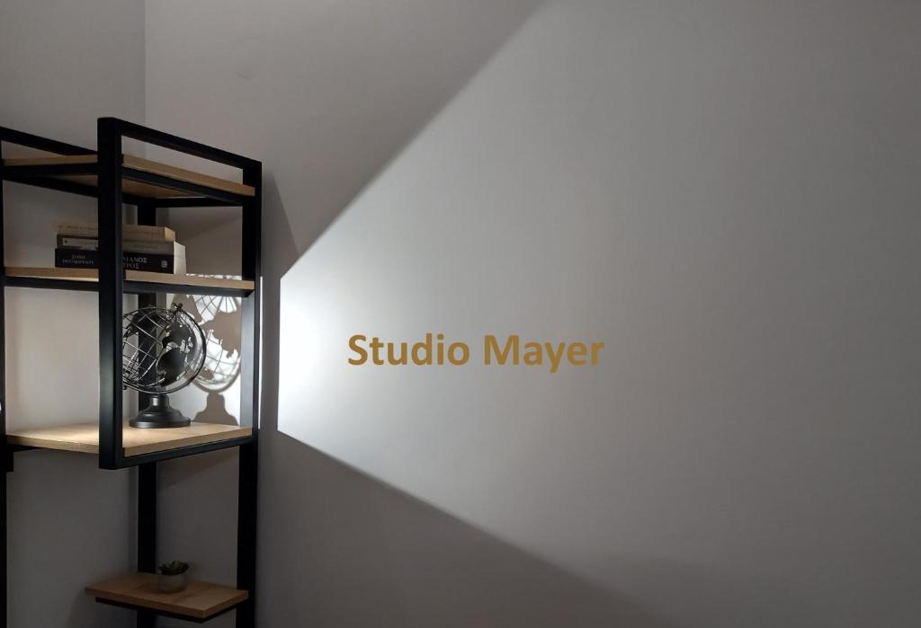 a shelf with a clock on a wall at Studio Mayer in Patra