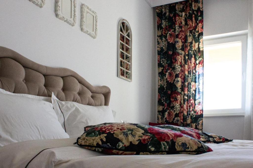 a bedroom with a bed with a pillow on it at Alma Rezidence in Turda