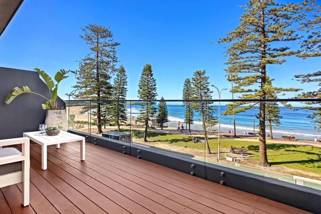 a balcony with a view of the beach at Glorious Beachfront 3-Bed with Breathtaking Views in Deewhy