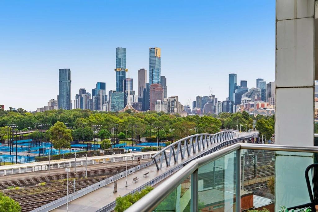 a view of a city skyline with a train at Spacious 3-Bed Apartment by the MCG in Melbourne