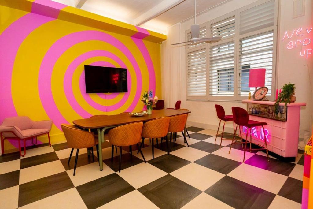 a dining room with a table and a target wall at Fun and Cheeky 70s Styled City Apartment in Melbourne