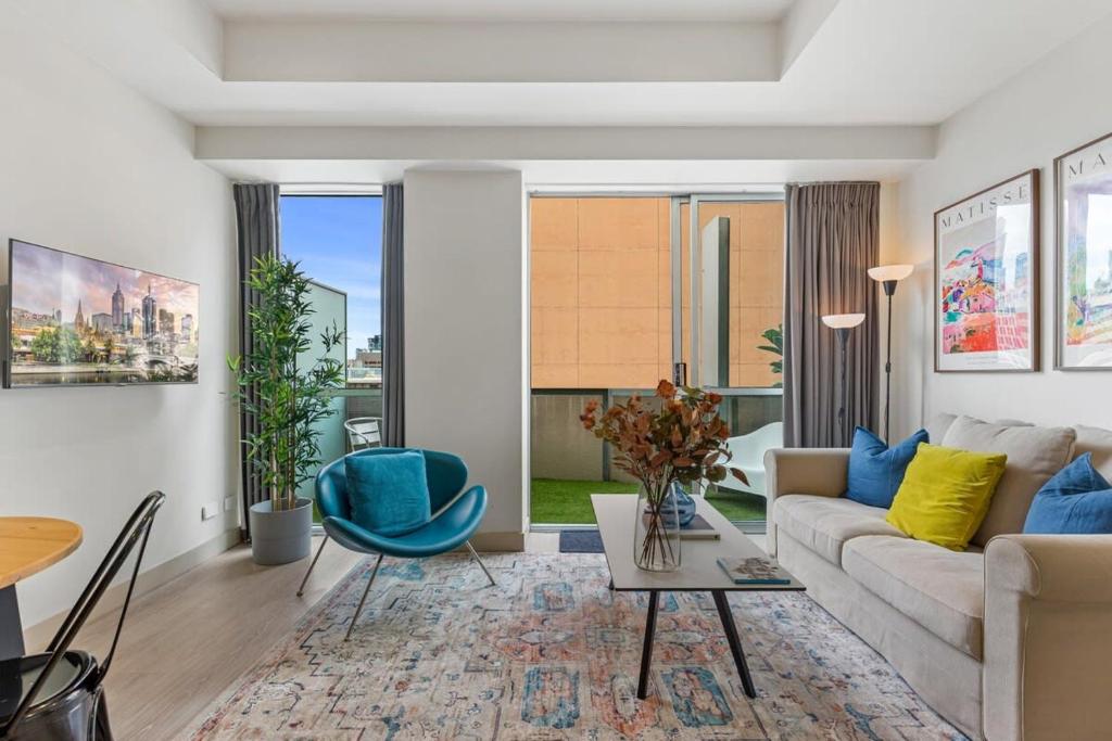 a living room with a couch and a table at Sophisticated CBD 2-Bed Apartment by Yarra River in Melbourne