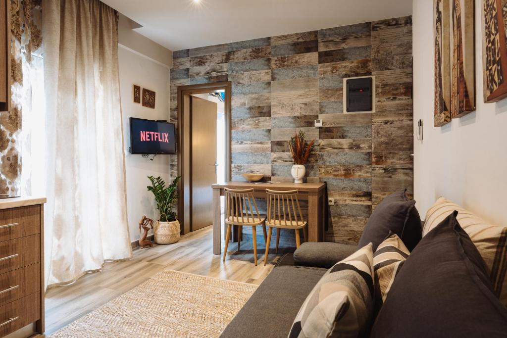 a living room with a wooden accent wall at Lef Apartment in Thessaloniki