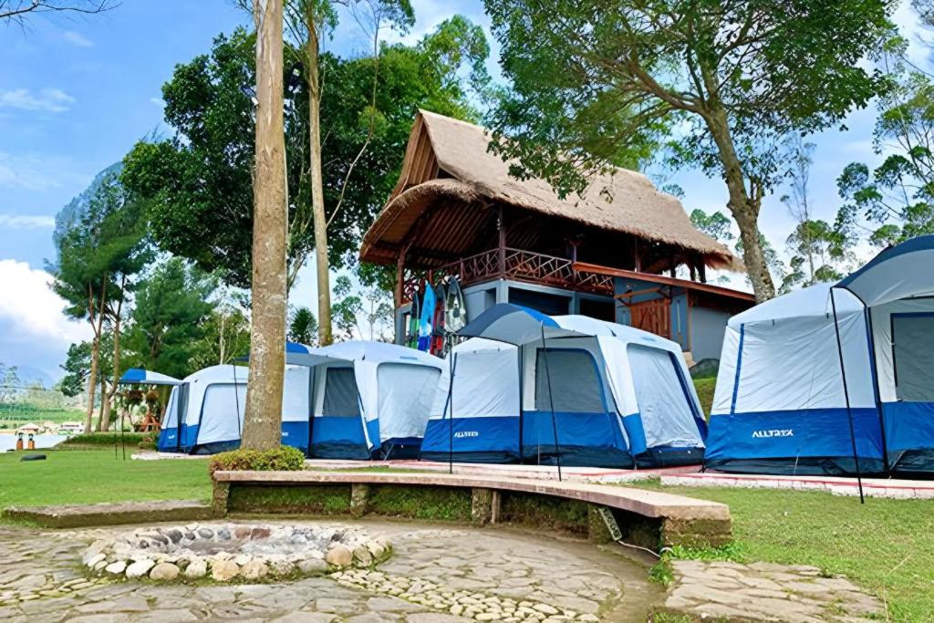 a row of tents in front of a building at Camping situ cileunca in Palayangan