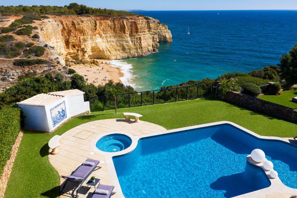 a swimming pool with a view of the ocean at Seafront View next to the famous “Benagil Caves” in Benagil