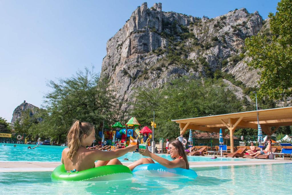 twee meisjes in het zwembad in een resort bij Camping Zoo in Arco