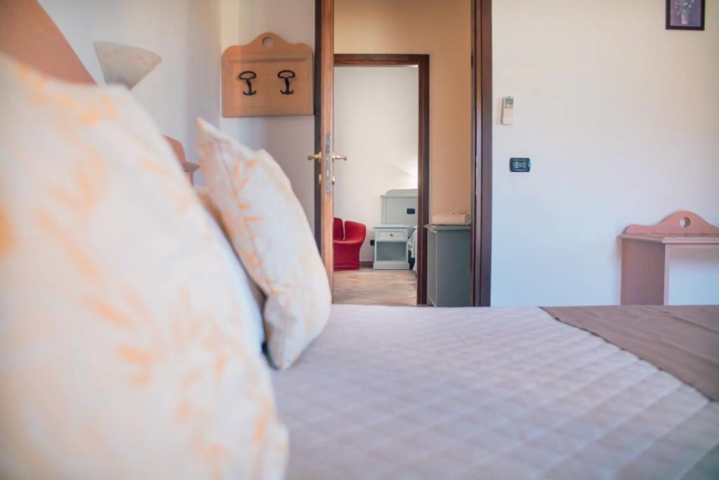 Postel nebo postele na pokoji v ubytování Hotel Cardedu