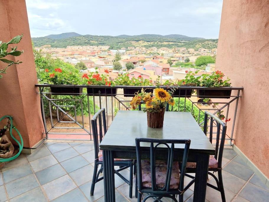 a table and chairs on a balcony with a view at La Terrazza in Villasimius