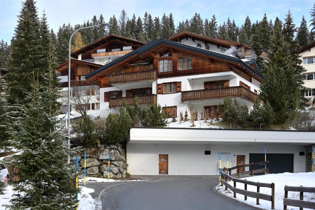 a house in the mountains with a driveway at Chesa Igna in Arosa