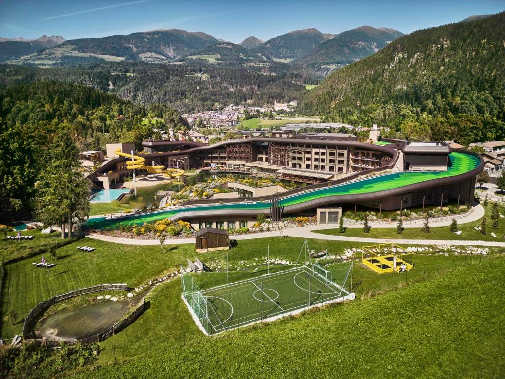 an aerial view of a resort with a tennis court at Falkensteiner Family Resort Lido Superior in Chienes