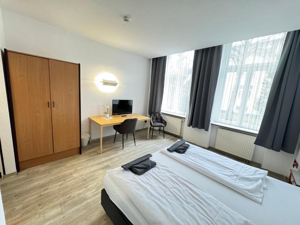 Postel nebo postele na pokoji v ubytování Appartement-Hotel Rostock