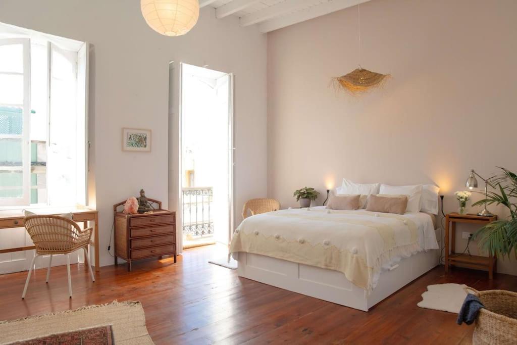 um quarto branco com uma cama, uma mesa e cadeiras em Bálsamo em Arucas