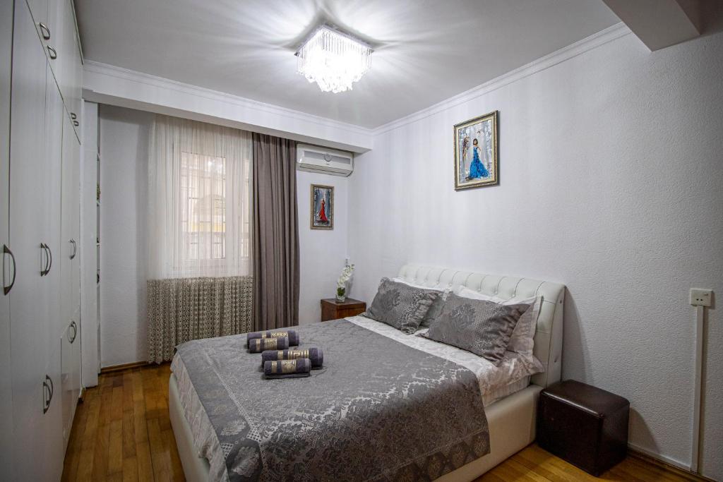 a bedroom with a bed with candles on it at Cozy Apartment on Kostava in Tbilisi City