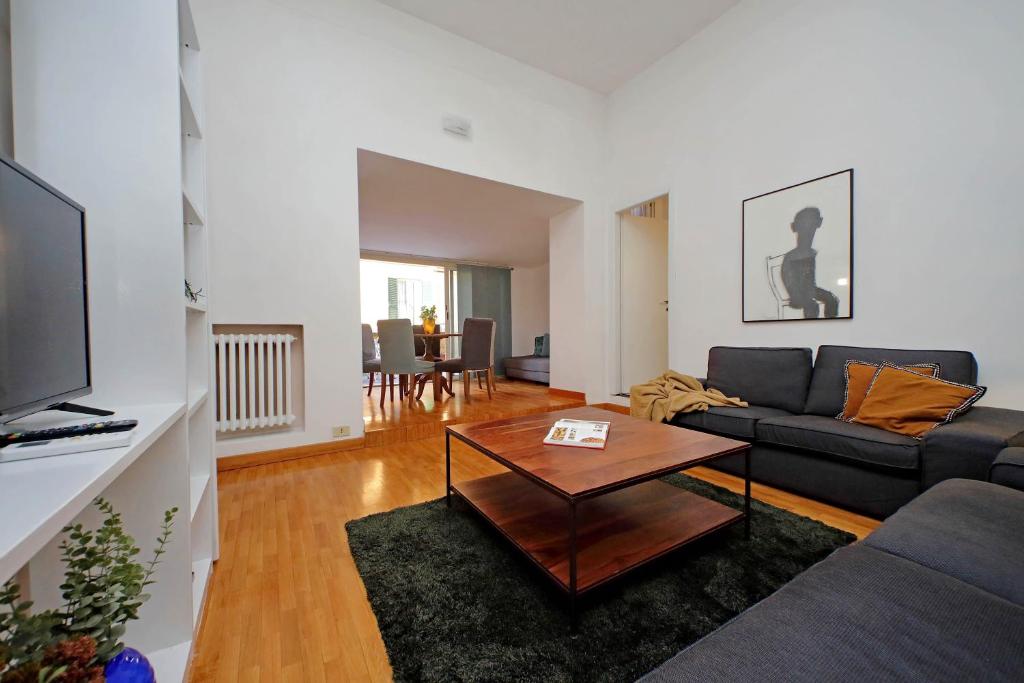 a living room with a couch and a coffee table at Amleto Apartments in Rome