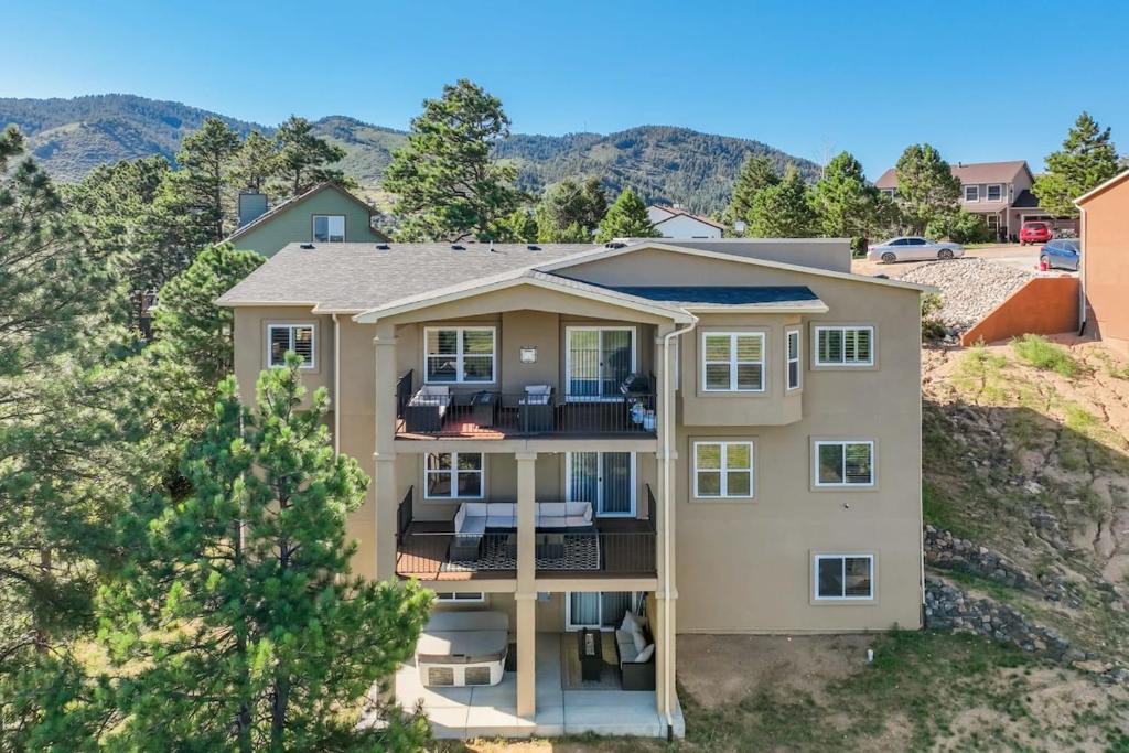 an aerial view of a house with mountains in the background at Stargazer Paradise - Top Spot Hot Tub Gym Man Cave in Monument