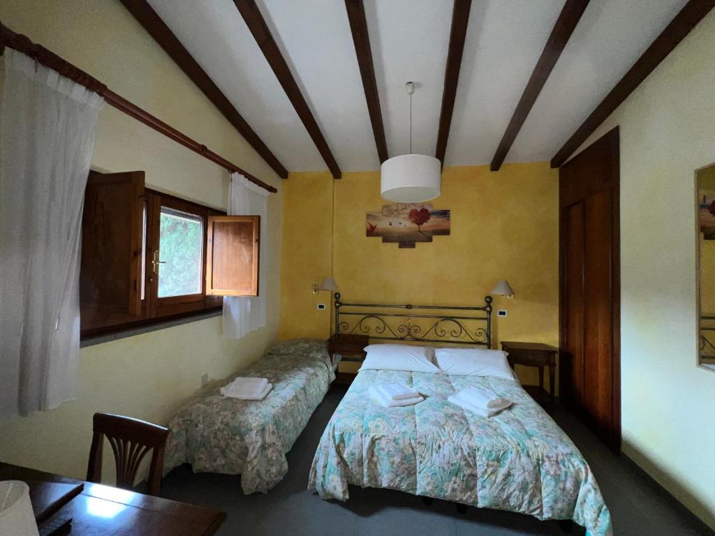Postel nebo postele na pokoji v ubytování Hotel Villalago trasimeno