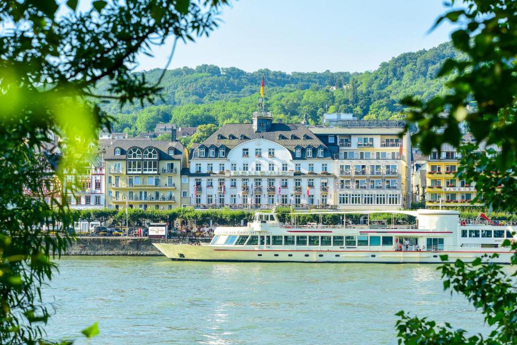 a boat on the river in front of buildings at Bellevue Rheinhotel in Boppard