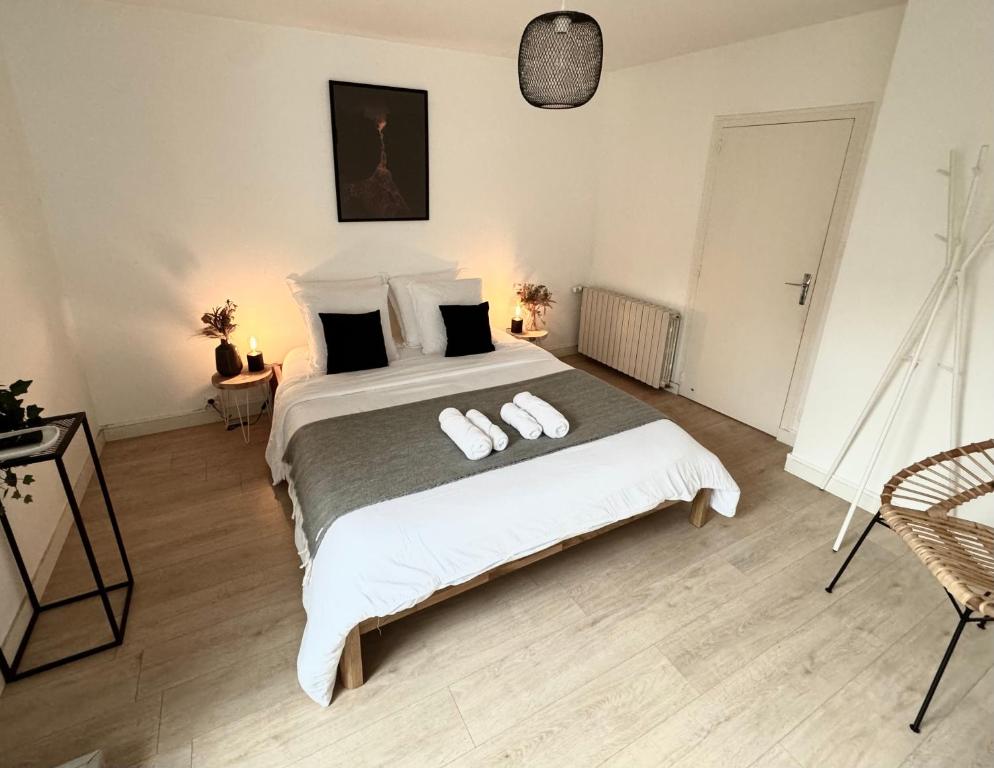 a bedroom with a large bed with two towels on it at Lava Studio in Poitiers