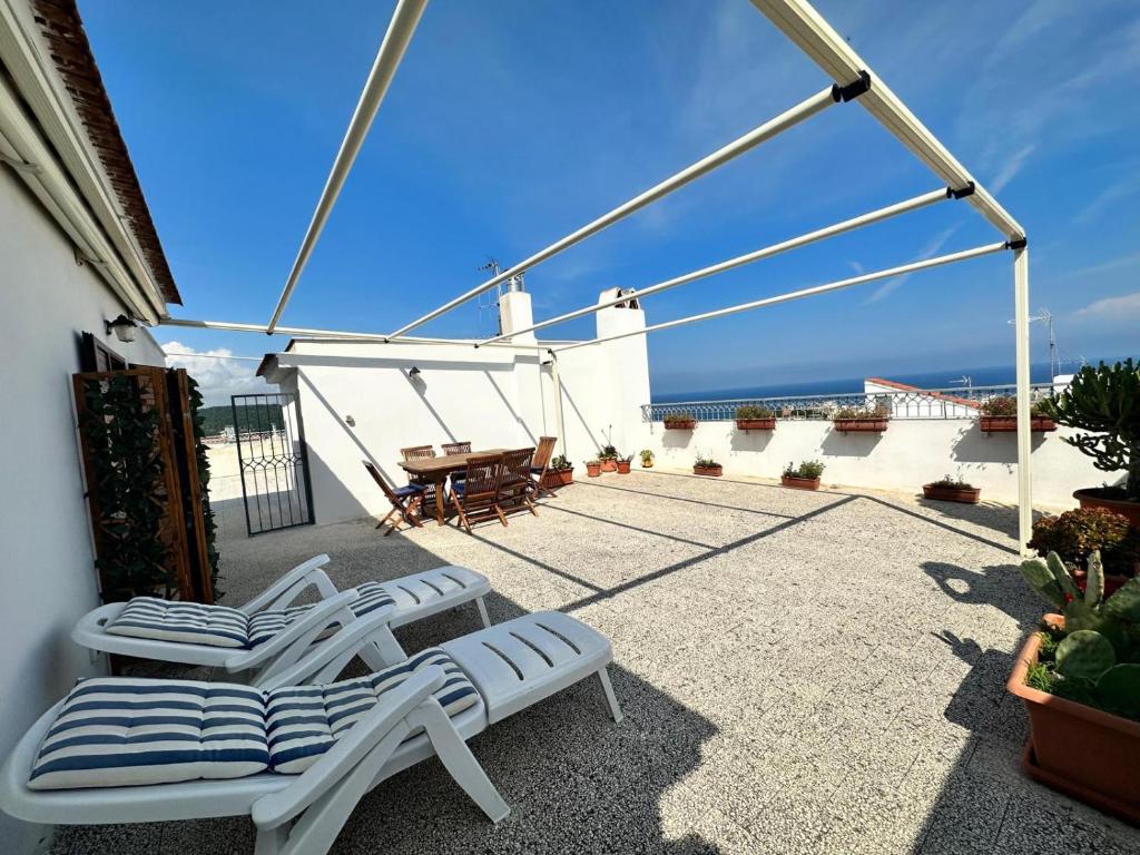 d'une terrasse avec 2 chaises longues et une table. dans l'établissement Da Carlino, à Peschici