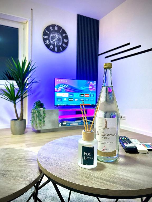 a bottle of wine on a table in a living room at Diamond Apartments: Residenz Dreiländereck nahe Flughafen in Herten