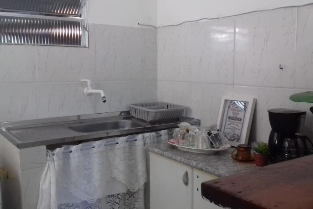 a kitchen with a sink and a counter top at Penedo - Quitinete para temporada in Itatiaia