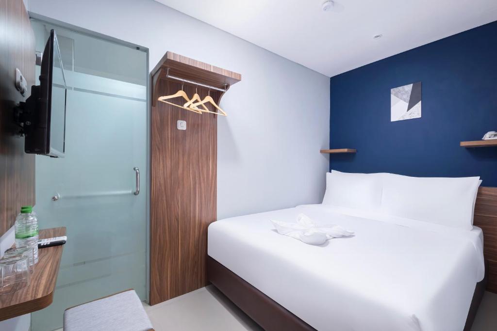 Postel nebo postele na pokoji v ubytování Gold Hotel Simpang Lima