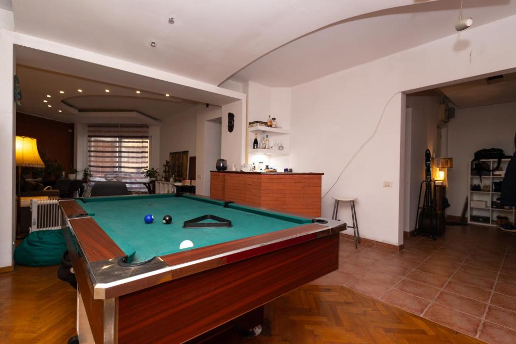 uma mesa de bilhar no meio de uma sala de estar em sharing retro vintage luxury apartment em Bucareste