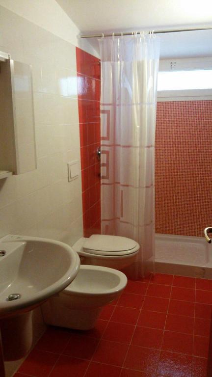 a bathroom with a toilet and a sink and a shower at B&B SanteBice in Polignano a Mare