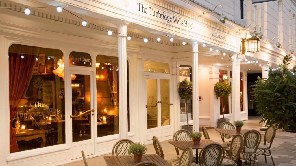 a restaurant with tables and chairs in front of a building at The Tunbridge Wells Hotel in Royal Tunbridge Wells